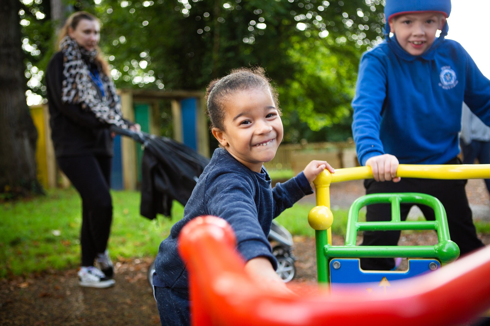 Girl and boy enjoy dbdplay installed play area at St. Rose's school