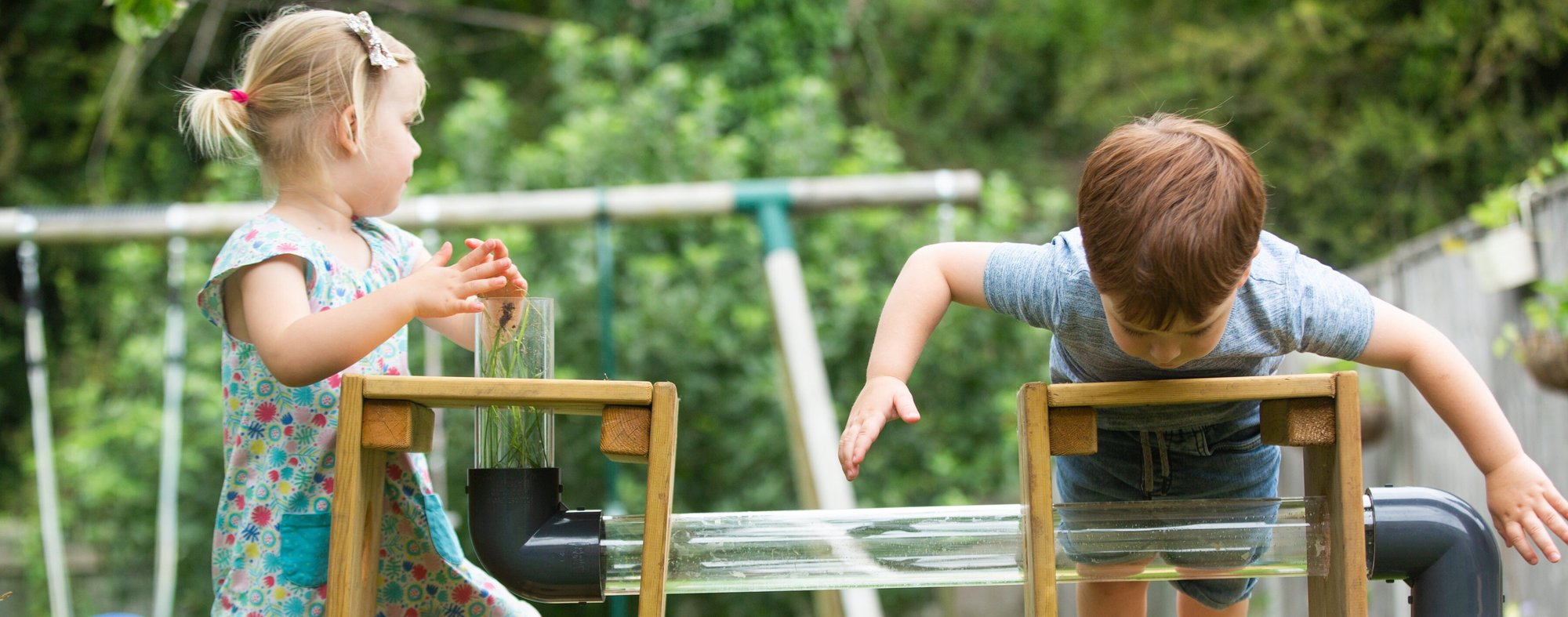 Two young kids playing with their tiny builders play equipment